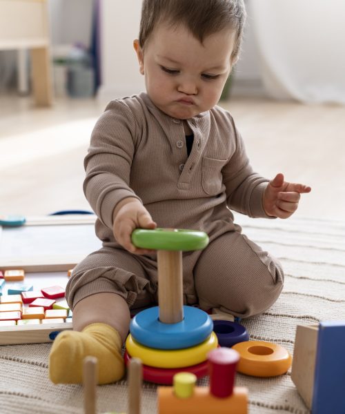 kid-playing-with-colorful-toys-full-shot